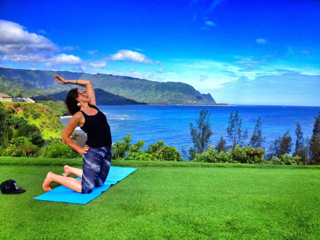 Hawaii, Kauai, Woman doing yoga on beach … – License image